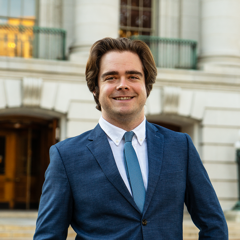 Michael Vickerman smiling in front of Wisconsin state capitol building